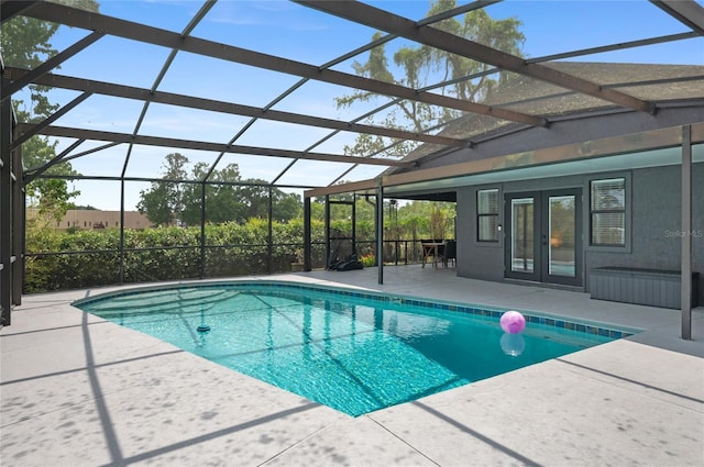swimming pool featuring french doors, a patio, and glass enclosure