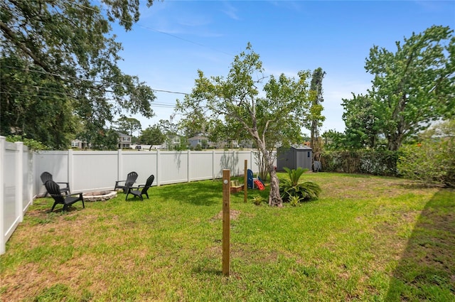 view of yard with a shed, an outbuilding, and an outdoor fire pit