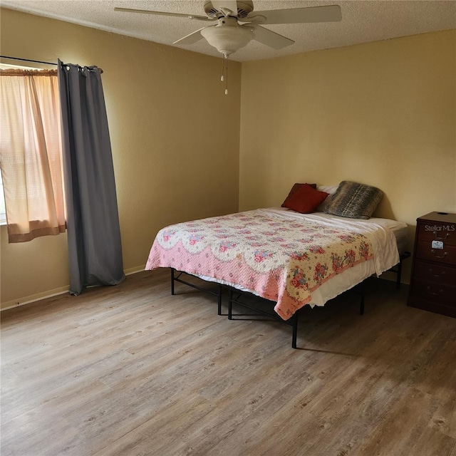 434 Windmeadows St Unit 434, Altamonte Springs, FL 32701 - bedroom featuring wood finished floors, baseboards, ceiling fan, and a textured ceiling
