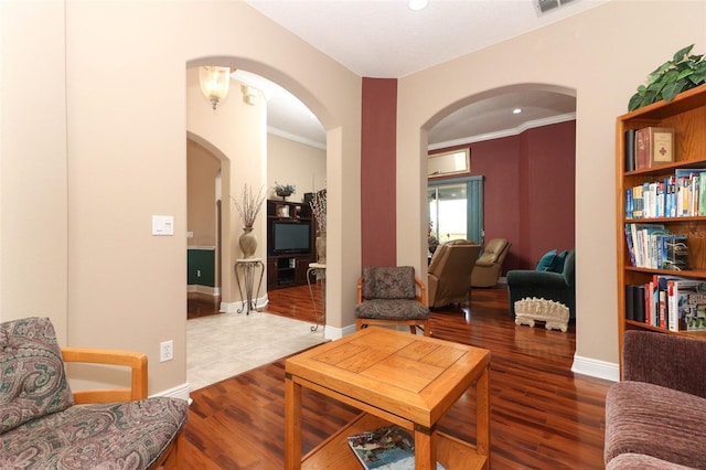 4201 Old Trafford Way, Orlando, FL 32810 - living room with arched walkways, wood finished floors, ornamental molding, baseboards, and recessed lighting