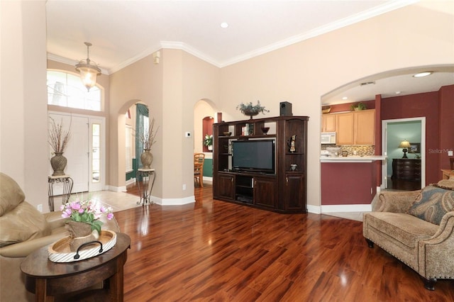 4201 Old Trafford Way, Orlando, FL 32810 - living area featuring arched walkways, wood finished floors, crown molding, baseboards, and recessed lighting