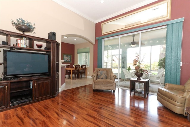 4201 Old Trafford Way, Orlando, FL 32810 - living room featuring arched walkways, crown molding, a ceiling fan, and wood finished floors