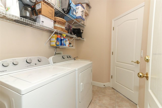 4201 Old Trafford Way, Orlando, FL 32810 - laundry area with washer and dryer, light tile patterned floors, and baseboards
