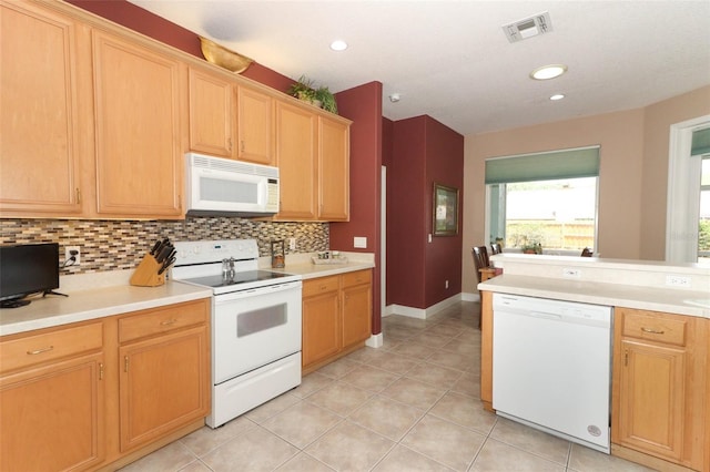 4201 Old Trafford Way, Orlando, FL 32810 - kitchen with white appliances, light tile patterned floors, decorative backsplash, light countertops, and recessed lighting