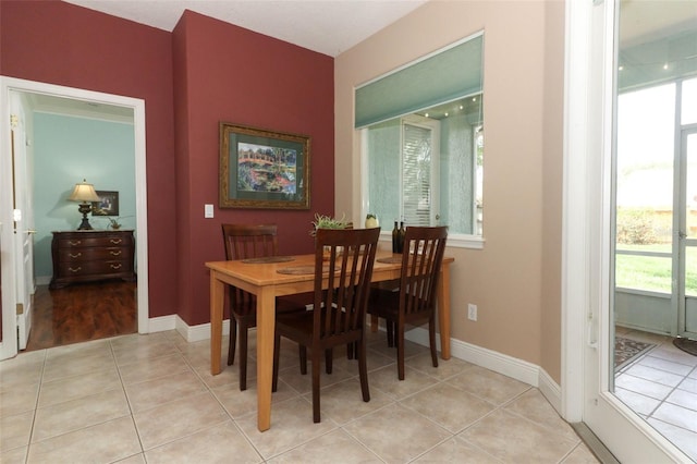 4201 Old Trafford Way, Orlando, FL 32810 - dining room featuring light tile patterned flooring and baseboards