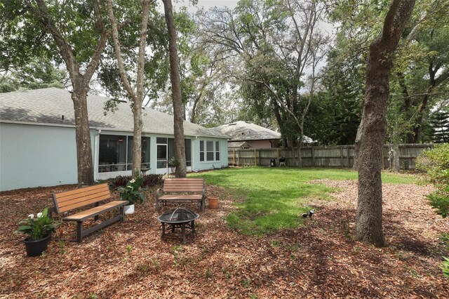 4201 Old Trafford Way, Orlando, FL 32810 - view of yard featuring an outdoor fire pit and a sunroom