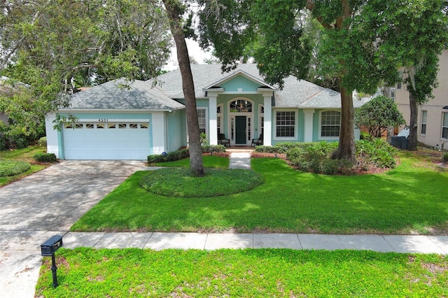 4201 Old Trafford Way, Orlando, FL 32810 - ranch-style home with stucco siding, an attached garage, concrete driveway, a front yard, and a shingled roof