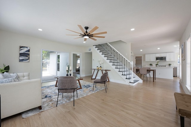 712 Maryland Ave, Saint Cloud, FL 34769 - living room with stairway, light wood-style floors, ceiling fan, recessed lighting, and baseboards