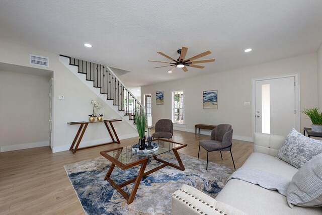 712 Maryland Ave, Saint Cloud, FL 34769 - living room with stairway, light wood-style floors, recessed lighting, baseboards, and a textured ceiling