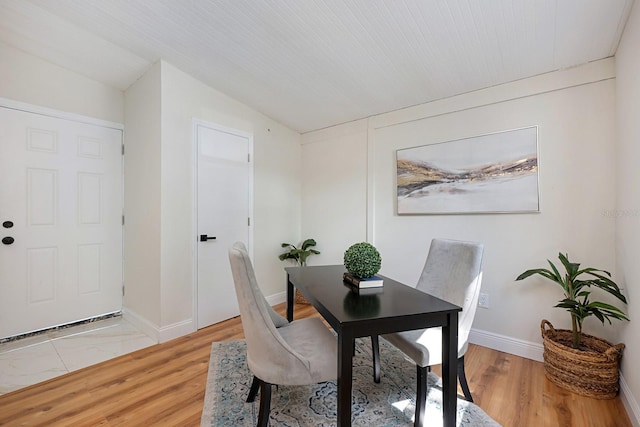 712 Maryland Ave, Saint Cloud, FL 34769 - dining space with vaulted ceiling, light wood-style flooring, and baseboards