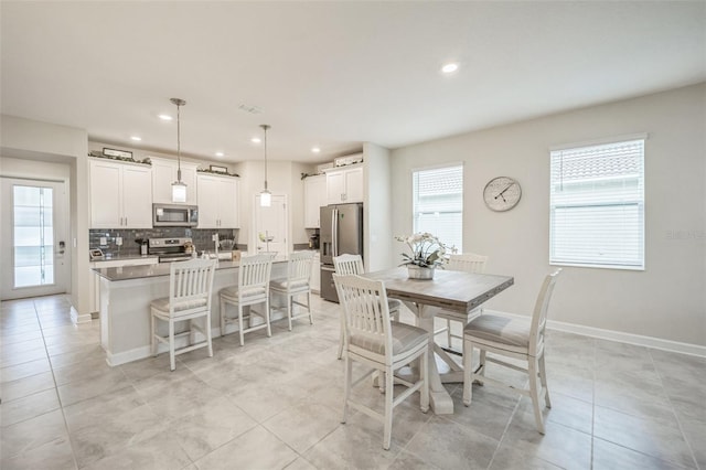 8907 Fallen Oak, Davenport, FL 33897 - dining space featuring light tile patterned flooring, recessed lighting, and baseboards