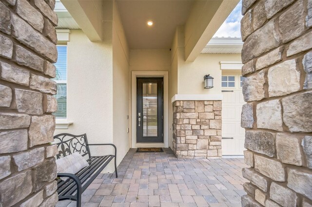 8907 Fallen Oak, Davenport, FL 33897 - view of exterior entry with stucco siding and stone siding