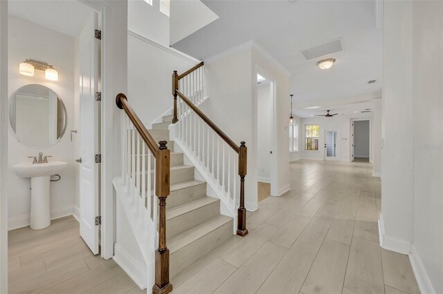 13913 Hahn Ln, Orlando, FL 32827 - stairs featuring wood finished floors, baseboards, and a ceiling fan