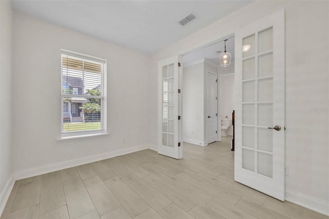 13913 Hahn Ln, Orlando, FL 32827 - unfurnished room featuring french doors, baseboards, and light wood-type flooring