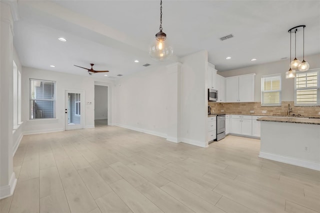 13913 Hahn Ln, Orlando, FL 32827 - unfurnished living room featuring light wood-type flooring, ceiling fan, baseboards, a sink, and recessed lighting