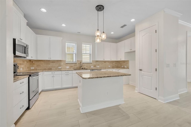 13913 Hahn Ln, Orlando, FL 32827 - kitchen featuring stainless steel appliances, backsplash, light stone countertops, and recessed lighting