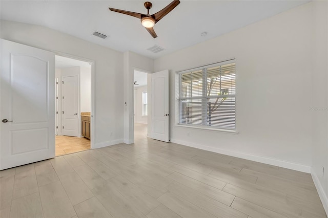 13913 Hahn Ln, Orlando, FL 32827 - unfurnished bedroom with baseboards, light wood-type flooring, and ensuite bath