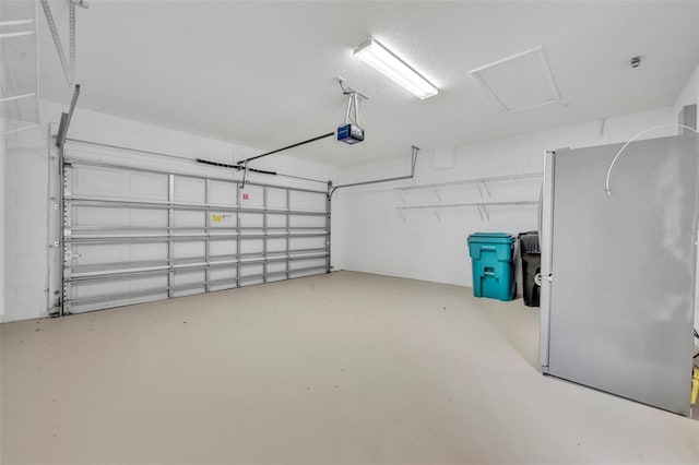 13913 Hahn Ln, Orlando, FL 32827 - garage featuring freestanding refrigerator, a garage door opener, and concrete block wall
