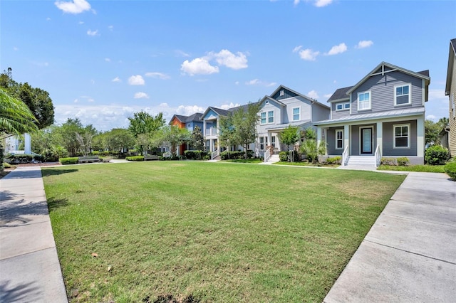 13913 Hahn Ln, Orlando, FL 32827 - view of front of property with a residential view, a front yard, metal roof, and a porch