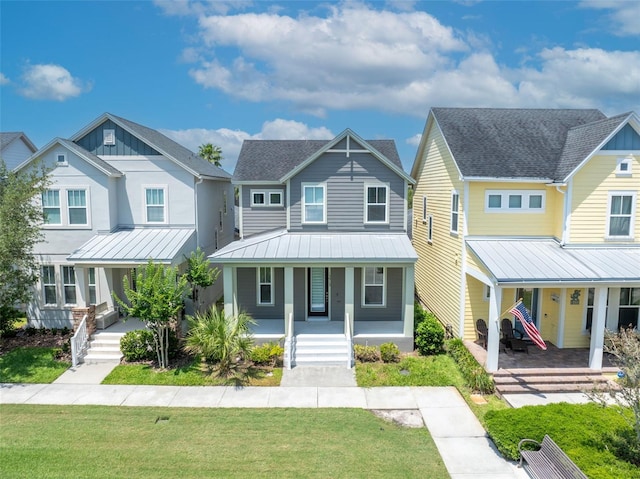 13913 Hahn Ln, Orlando, FL 32827 - view of front of home with a porch, a front lawn, a standing seam roof, and metal roof