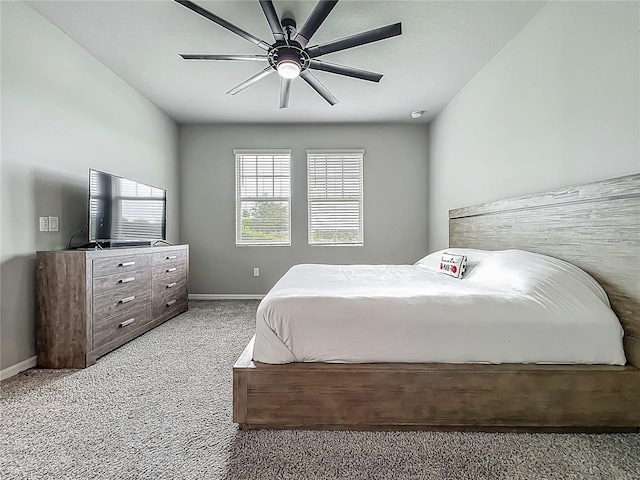 carpeted bedroom with baseboards and a ceiling fan