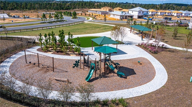view of community with a residential view and fence