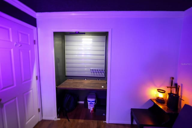 bedroom with wood finished floors and baseboards