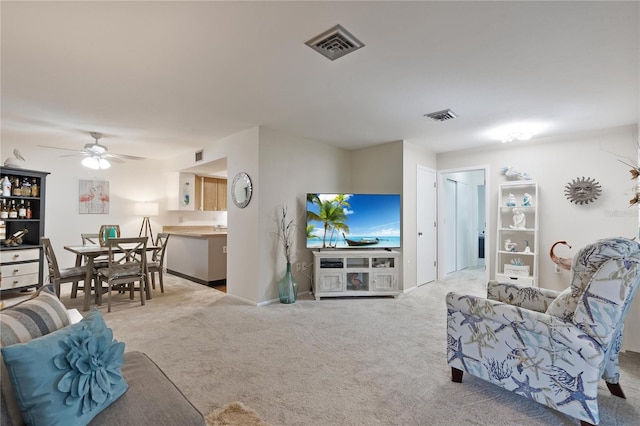 living room featuring carpet, ceiling fan, and baseboards