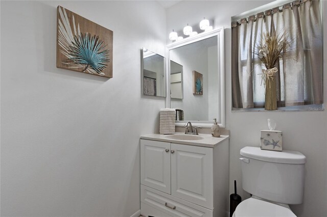 bathroom featuring toilet and vanity