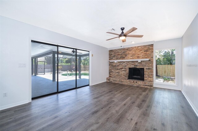 713 Coach Light Dr, Fern Park, FL 32730 - unfurnished living room featuring a ceiling fan, wood finished floors, baseboards, and a fireplace