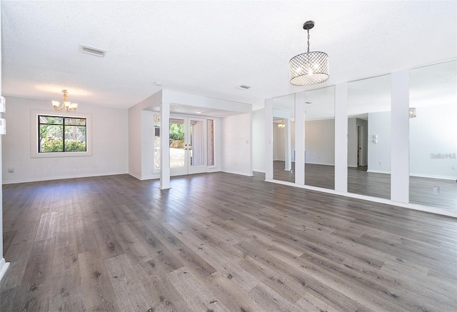 713 Coach Light Dr, Fern Park, FL 32730 - unfurnished living room featuring a chandelier, wood finished floors, and baseboards