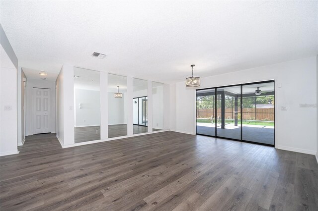 713 Coach Light Dr, Fern Park, FL 32730 - unfurnished living room featuring dark wood-style flooring and baseboards