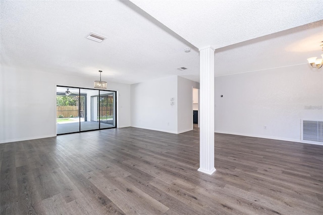 713 Coach Light Dr, Fern Park, FL 32730 - unfurnished living room featuring a chandelier, dark wood-style flooring, a textured ceiling, and baseboards