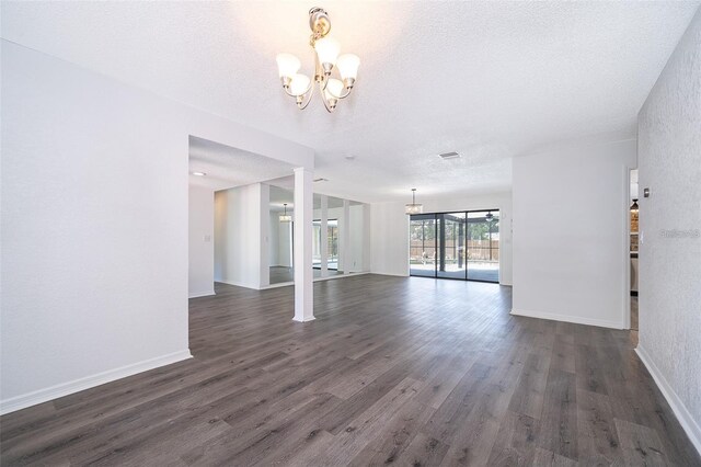 713 Coach Light Dr, Fern Park, FL 32730 - unfurnished dining area featuring a chandelier, dark wood-style floors, a textured ceiling, and baseboards