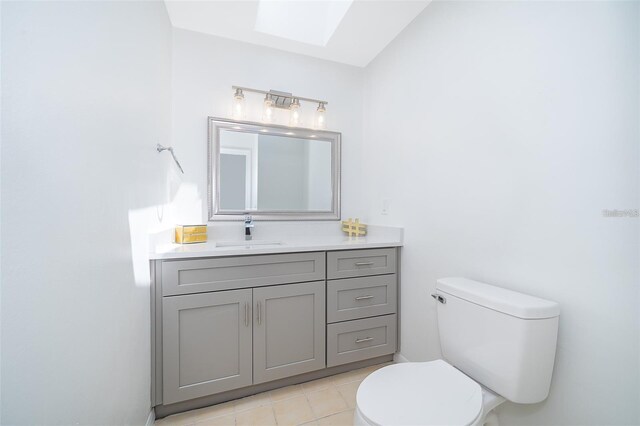 713 Coach Light Dr, Fern Park, FL 32730 - bathroom with toilet, a skylight, vanity, and tile patterned floors