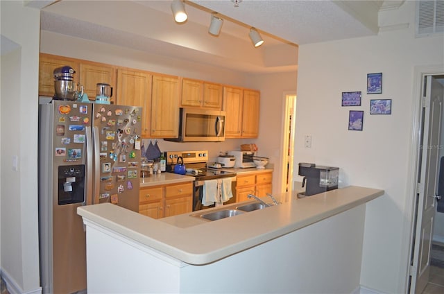 12212 Wild Iris Way Unit 106, Orlando, FL 32837 - kitchen with appliances with stainless steel finishes, a sink, a peninsula, light countertops, and light brown cabinetry