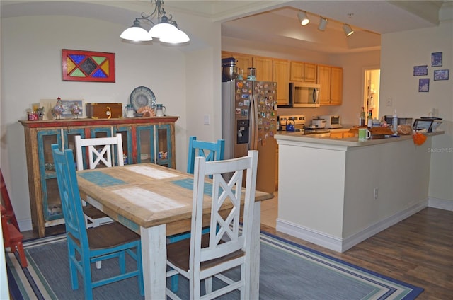 12212 Wild Iris Way Unit 106, Orlando, FL 32837 - dining space featuring wood finished floors and a chandelier