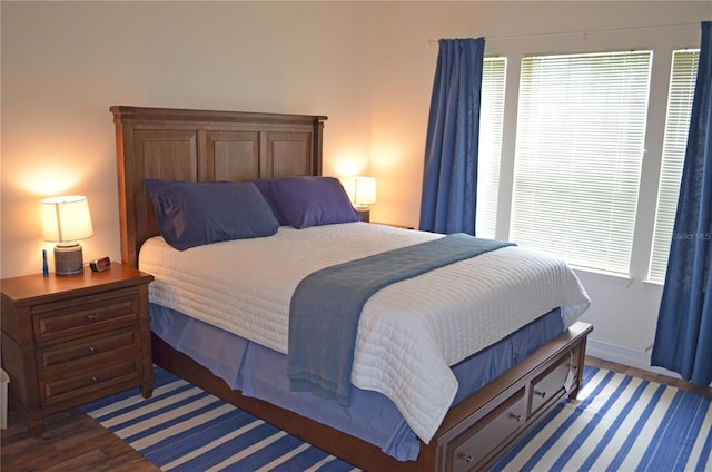 12212 Wild Iris Way Unit 106, Orlando, FL 32837 - bedroom with wood finished floors, multiple windows, and baseboards