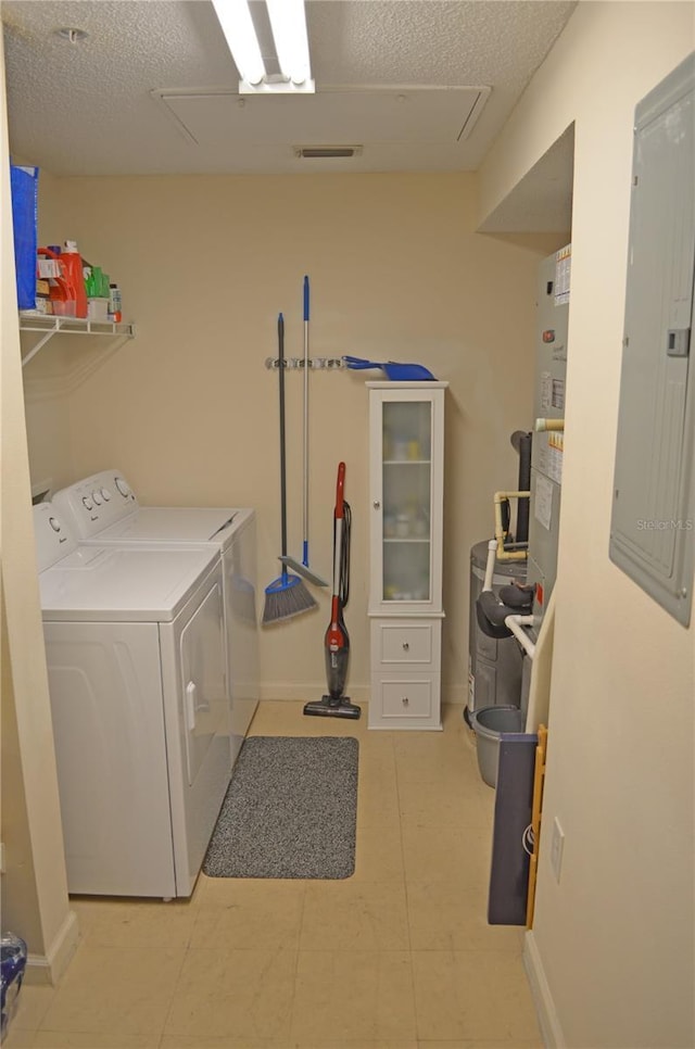 12212 Wild Iris Way Unit 106, Orlando, FL 32837 - laundry room with independent washer and dryer, electric panel, a textured ceiling, and baseboards