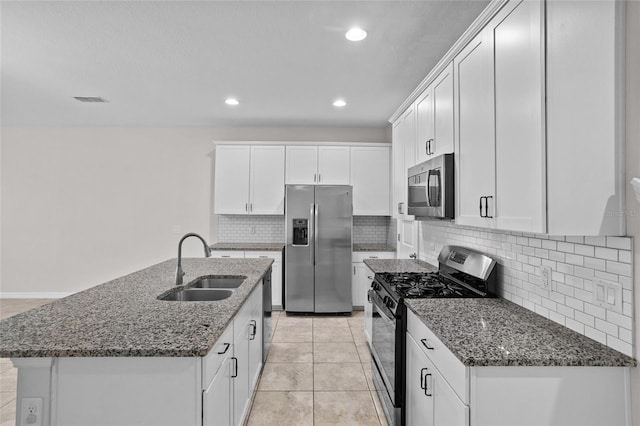 15651 Kinnow Mandarin Ln, Winter Garden, FL 34787 - kitchen featuring appliances with stainless steel finishes, a sink, white cabinets, tasteful backsplash, and recessed lighting
