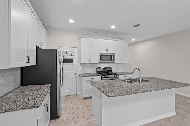 15651 Kinnow Mandarin Ln, Winter Garden, FL 34787 - kitchen with appliances with stainless steel finishes, a sink, light tile patterned floors, decorative backsplash, and recessed lighting