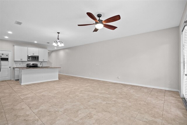 15651 Kinnow Mandarin Ln, Winter Garden, FL 34787 - unfurnished living room with a chandelier, a ceiling fan, recessed lighting, a sink, and baseboards