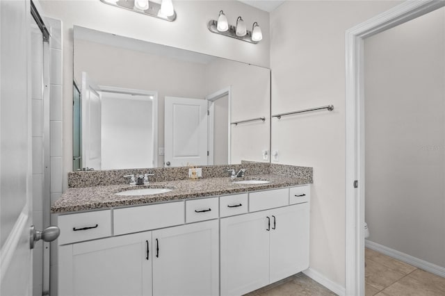 15651 Kinnow Mandarin Ln, Winter Garden, FL 34787 - full bathroom with toilet, double vanity, tile patterned flooring, and baseboards