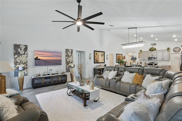 living room featuring a ceiling fan, light wood-style flooring, recessed lighting, high vaulted ceiling, and baseboards
