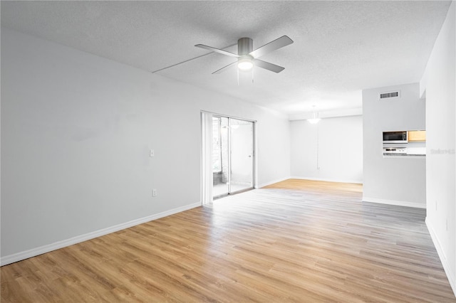 1163 Paseo Del Mar Unit B, Casselberry, FL 32707 - unfurnished room featuring ceiling fan, light wood-style floors, a textured ceiling, and baseboards