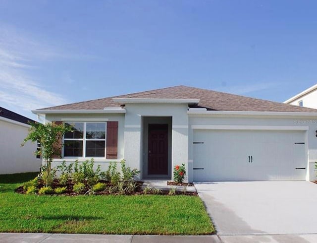 ranch-style house with a garage, concrete driveway, a front yard, stucco siding, and a shingled roof