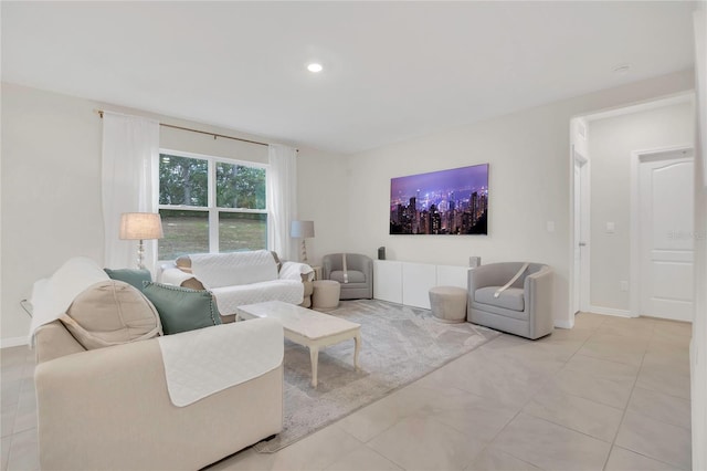 living area featuring light tile patterned floors, recessed lighting, and baseboards