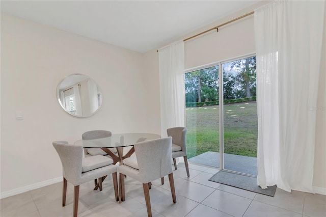 dining room with baseboards and light tile patterned floors
