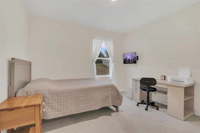 carpeted bedroom with baseboards and an office area