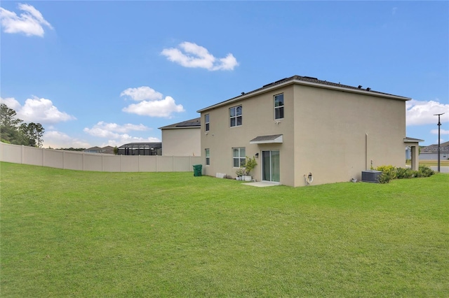 back of house with stucco siding and central AC unit